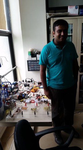 Chathura Suduwella at the Sustainable Computing Research Lab at the University of Colombo. The tangle of wires next to him represents a possible innovation in electric fencing that can help farms and villages protect themselves from elephants.